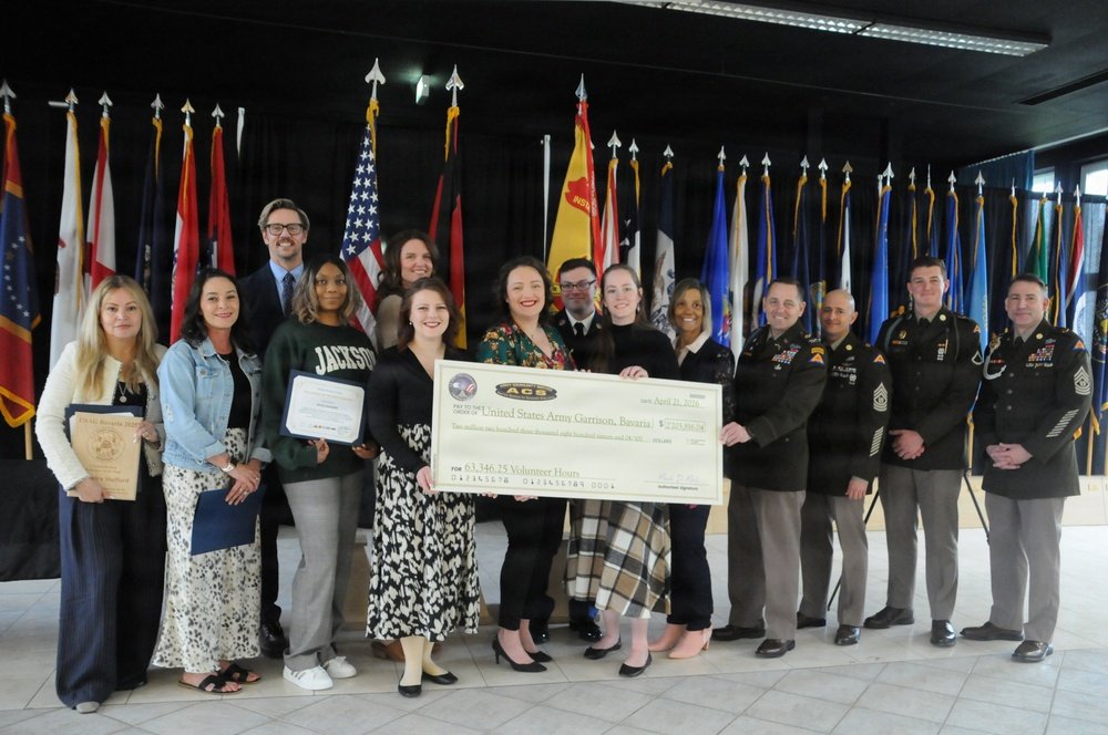 DVIDS – News – Volunteers commit thousands of hours to Hohenfels community USAG Bavaria volunteer group photo with check