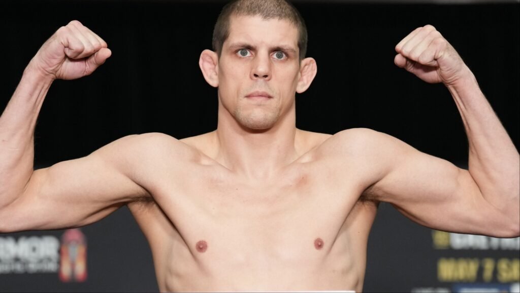 Joe Lauzon poses on the scale at the UFC 274 weigh-in