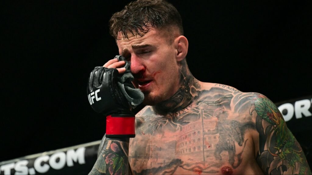 Joe Rogan defends Tom Aspinall against eye injury critics Tom Aspinall reacts after getting poked in the eyes during his fight at UFC 321