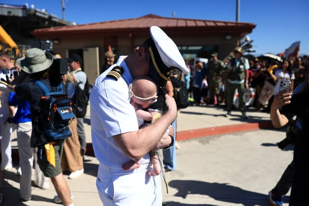 122 sailors aboard the Abraham Lincoln meet their children for the first time